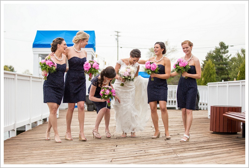 Bridesmaid helping bride with dress | Wentworth by the Sea wedding New Hampshire LAD Photography