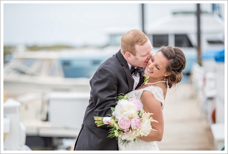 Bride and Groom share kiss on docks | Wentworth by the Sea wedding New Hampshire LAD Photography