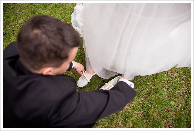 Groom helping bride with shoes - Jason and Angela's Hardy Farm Wedding in Fryeburg Maine