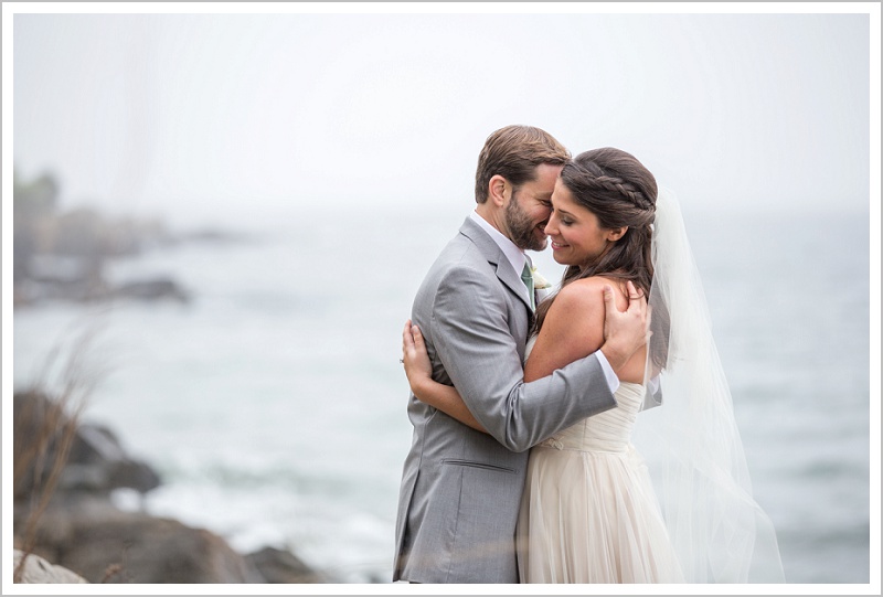 Bride and groom embrace by the water - Laura + Steve's York Harbor Inn Wedding | LAD Photography