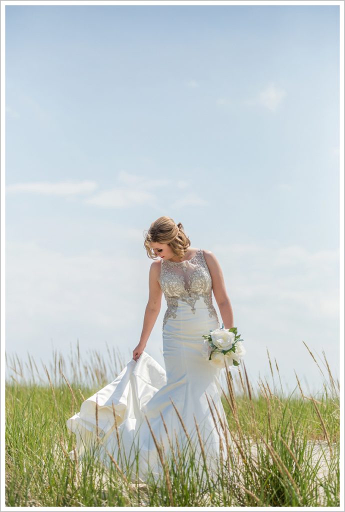 Bride in beach grass | Joseph and Breanne's Village by the Sea Wedding