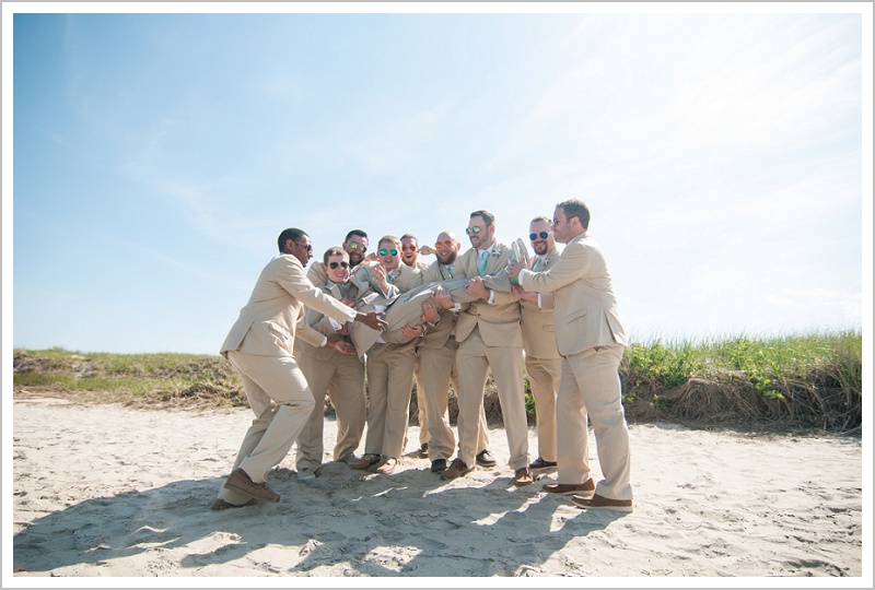 Groomsmen holding groom | Joseph and Breanne's Village by the Sea Wedding