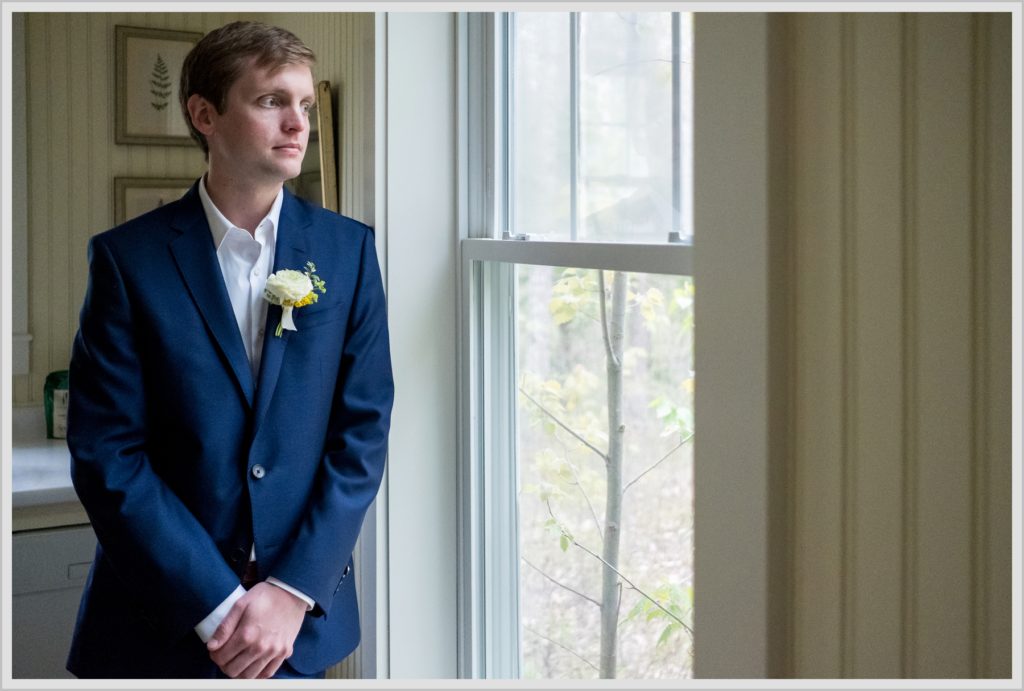 Katie and James' Hidden Pond Wedding | Groom waiting by window