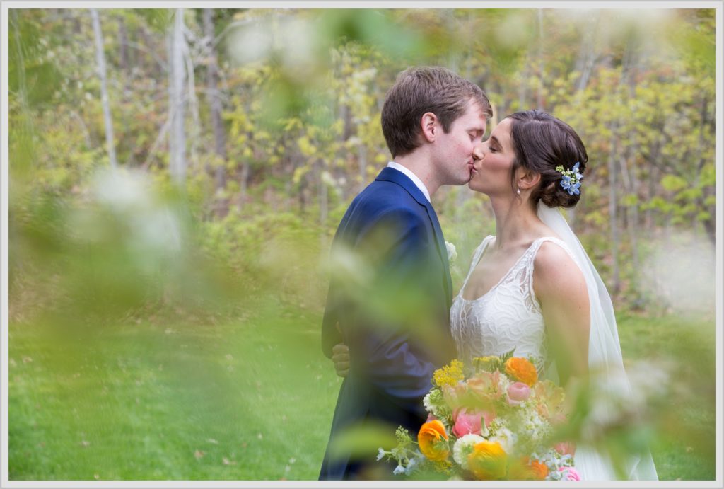 Katie and James' Hidden Pond Wedding | Kiss in the woods