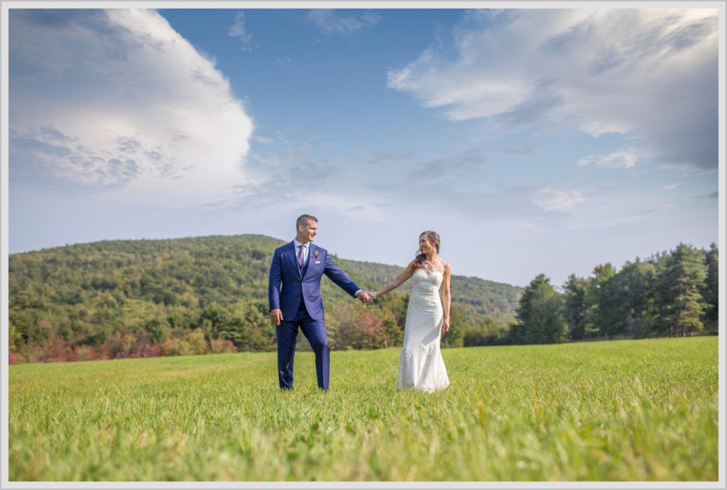 Dan and Amanda's Stone Mountain Arts Center Wedding Featured in Real Maine Weddings | bride and groom on hillside