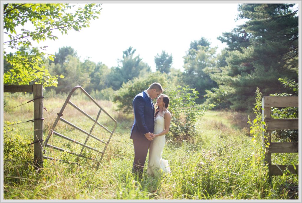 Dan and Amanda's Stone Mountain Arts Center Wedding Featured in Real Maine Weddings | bride and groom next to gate