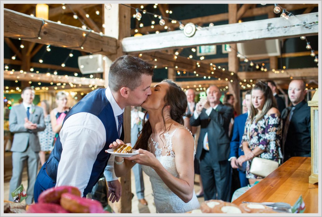 Dan and Amanda's Stone Mountain Arts Center Wedding Featured in Real Maine Weddings | Bride and groom at donut bar