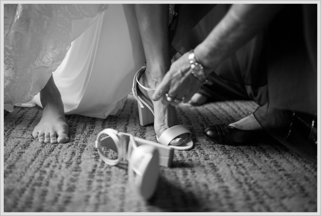 Dan and Amanda's Stone Mountain Arts Center Wedding Featured in Real Maine Weddings | Bride putting shoes on