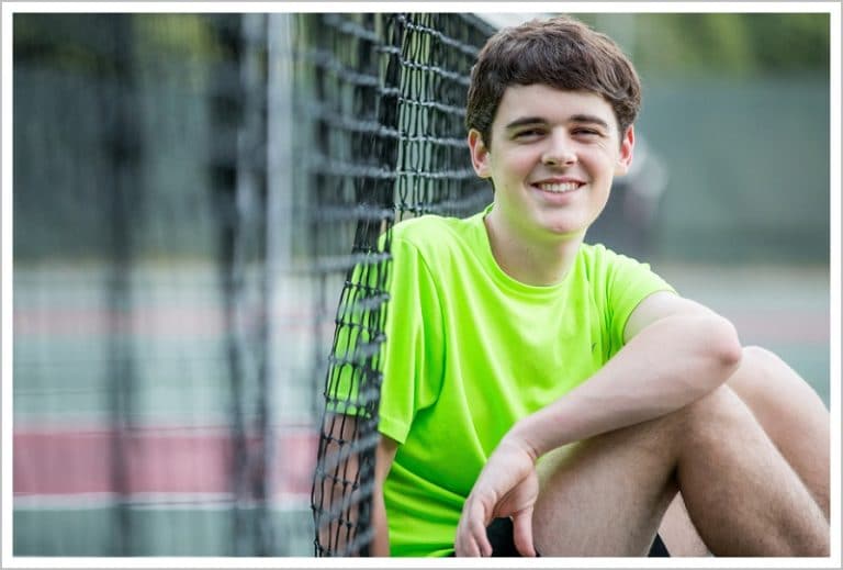 Mac against the tennis net | Hall-Dale Senior | LAD Photography