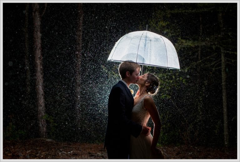 Katie and James' Hidden Pond Wedding | under an umbrella in the rain