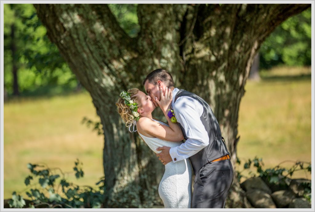 Ryan and Becca's New Hampshire Farm Wedding | kiss under a tree