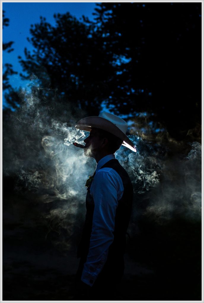 Ryan and Becca's New Hampshire Wedding | Groom with smoke from Cigar