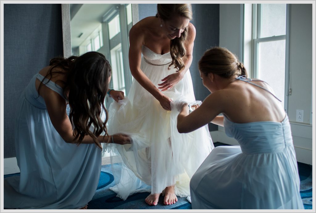 Brian + Tracy's Cliff House Wedding | bride getting help with dress