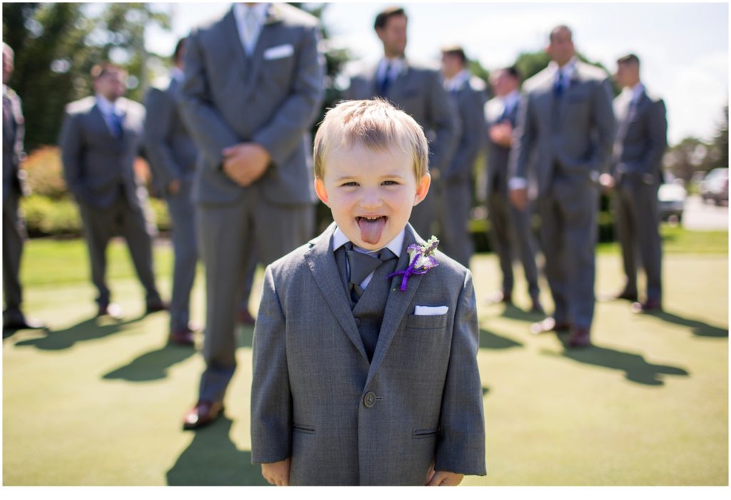 Katie and Eric's Dunegrass Wedding | ring bearer sticks out tongue