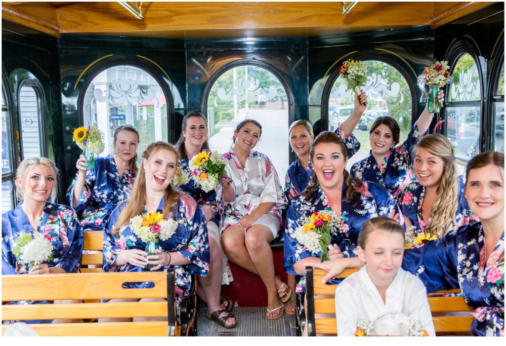 Katie and Eric's Dunegrass Wedding | Bride and bridesmaids in trolly