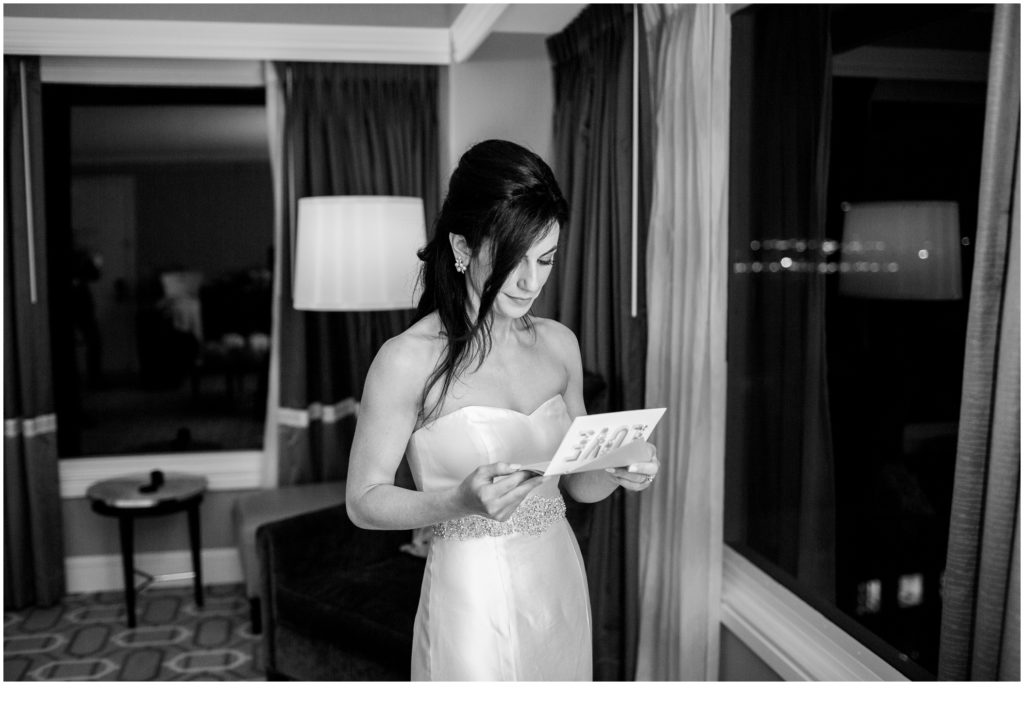 Bride reading note from groom | Jewish Wedding at Boston Harbor Hotel on New Years Eve