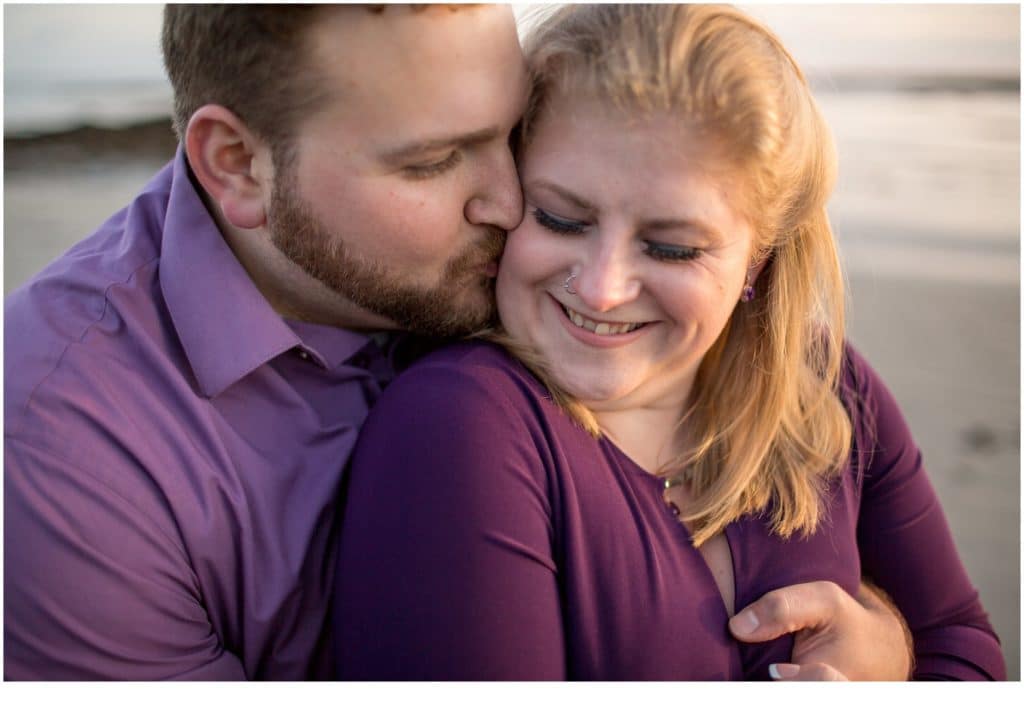 Kittery Point Engagement: Drew embracing Sarah close up on the rocks by the water