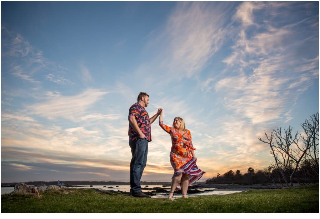 Kittery Point Engagement: Drew and Sarah in hawaiian shirts on the rocks by the water