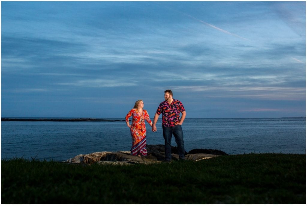 Kittery Point Engagement: Drew and Sarah in hawaiian shirts on the rocks by the water